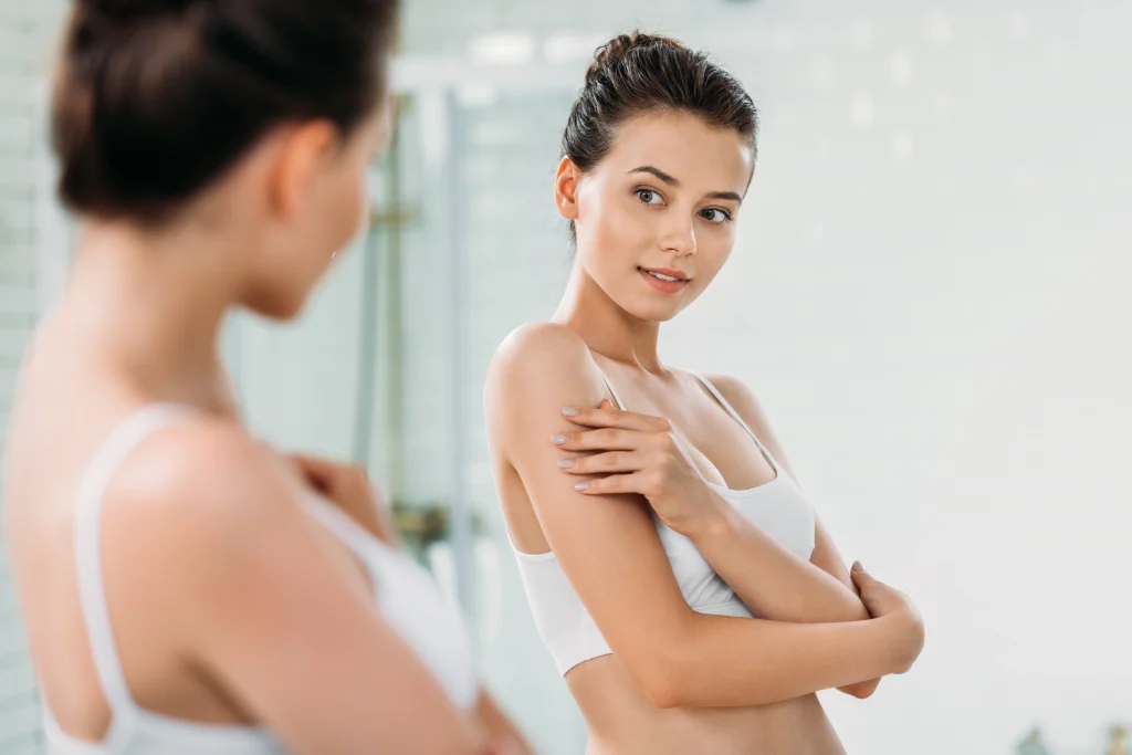 Tanned Woman looking in the mirror